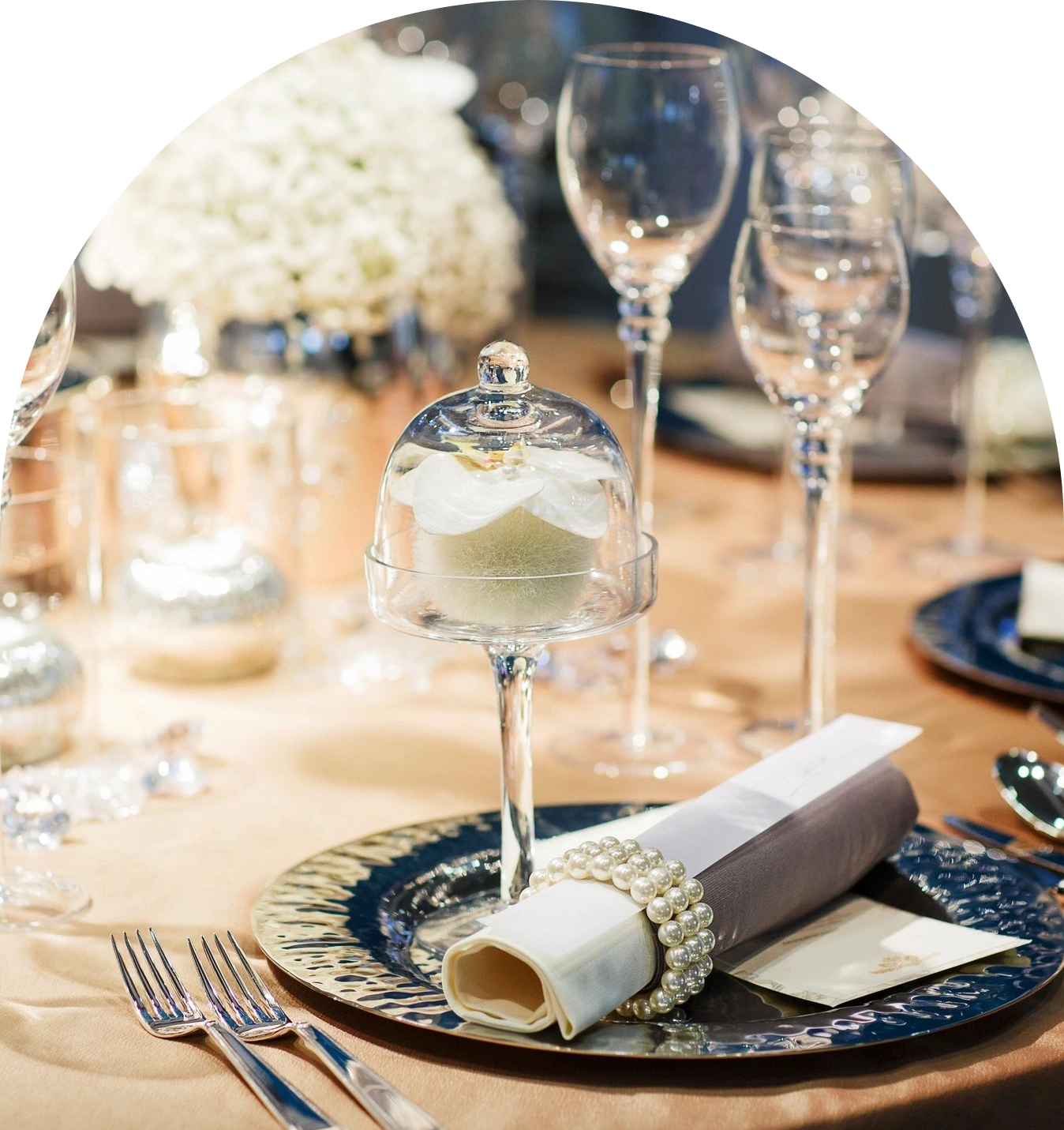 Elegant table setting with floral centerpiece and rolled napkin.