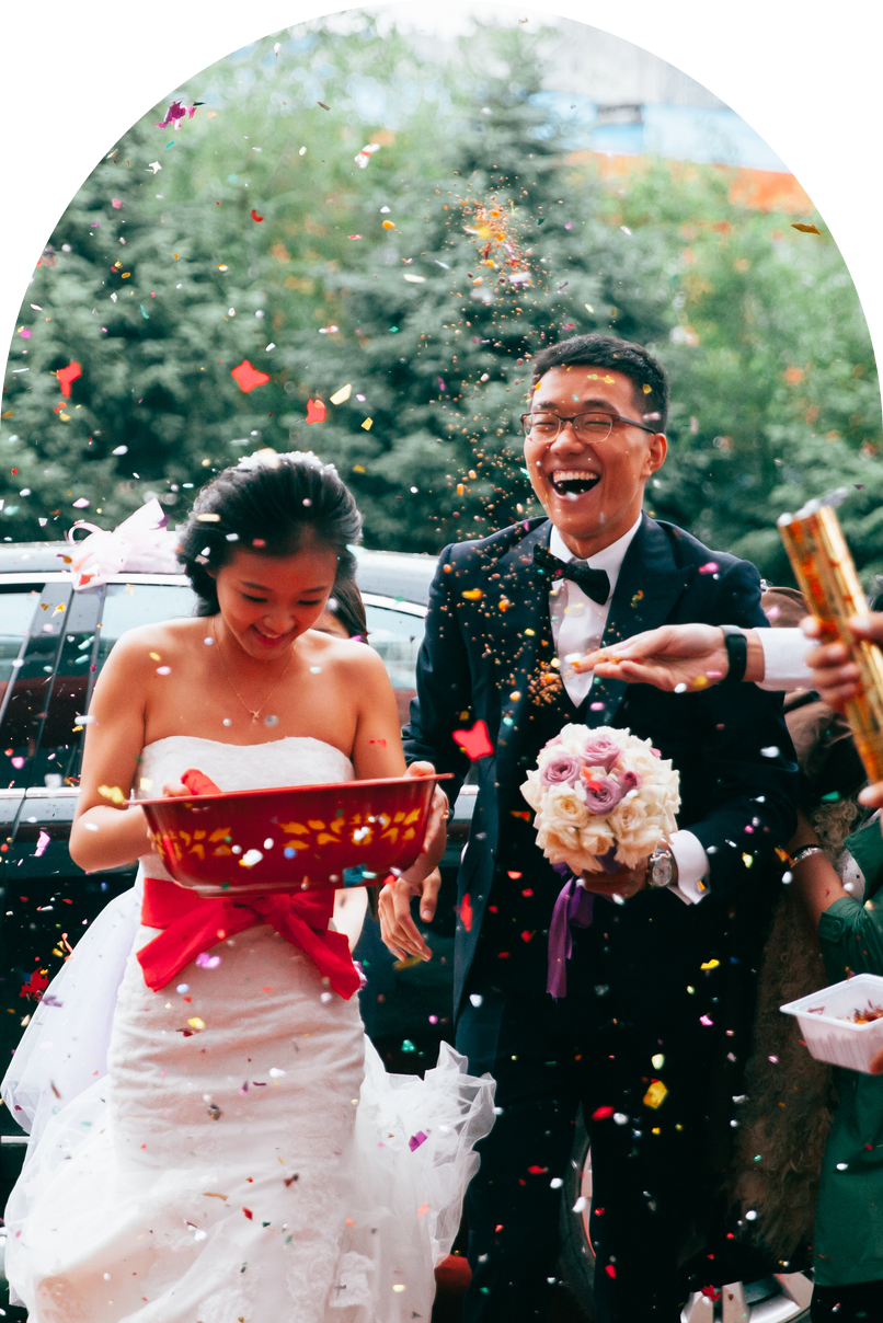 Joyful couple celebrating their wedding with confetti.