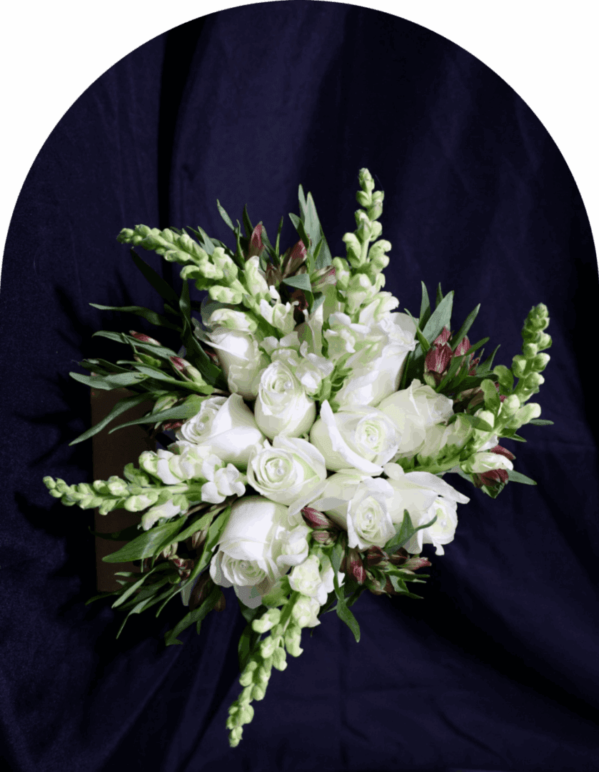 Elegant white floral bouquet with greenery on dark background.